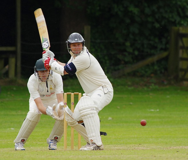 Dynamic image of a batsman hitting a powerful shot under neon lights.